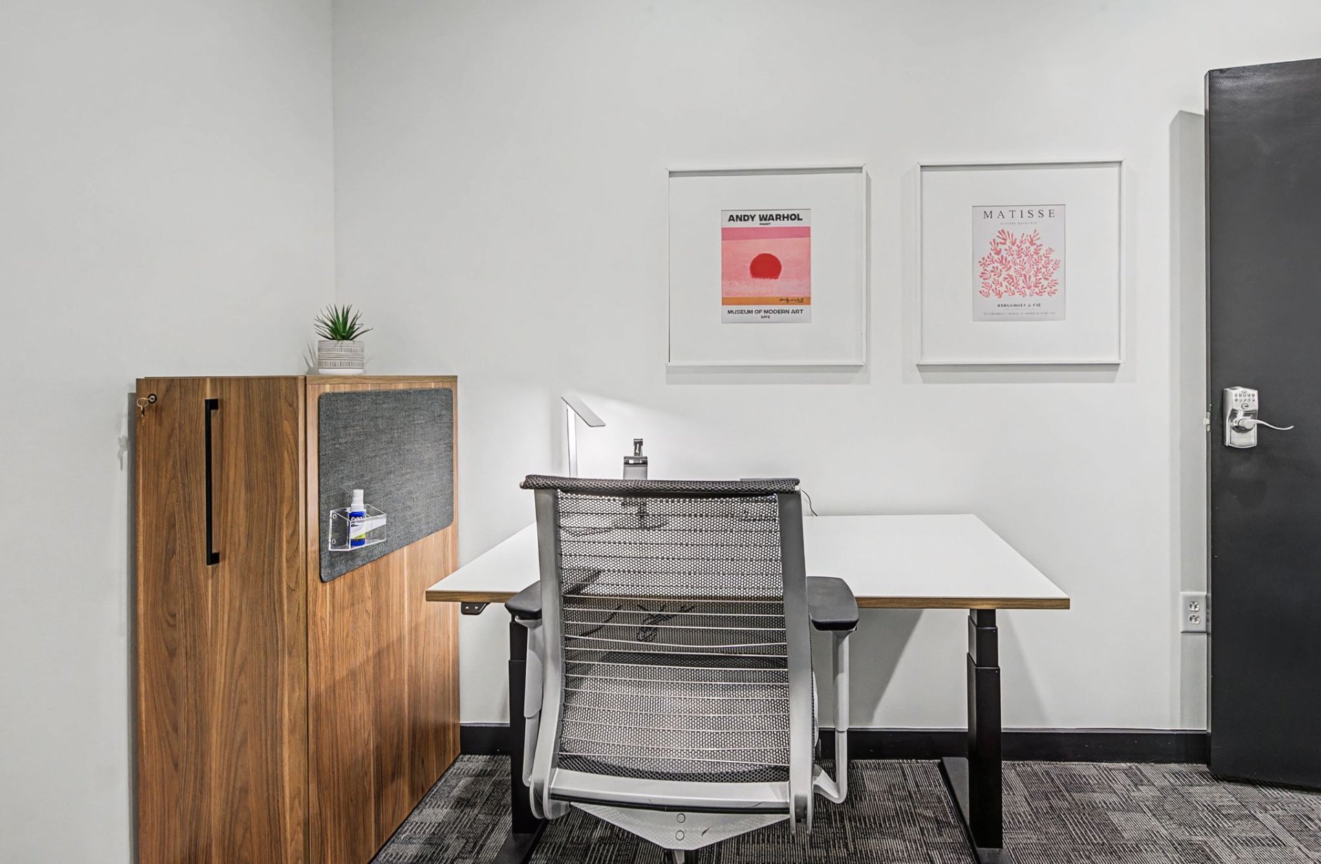 Private office desk with framed artwork