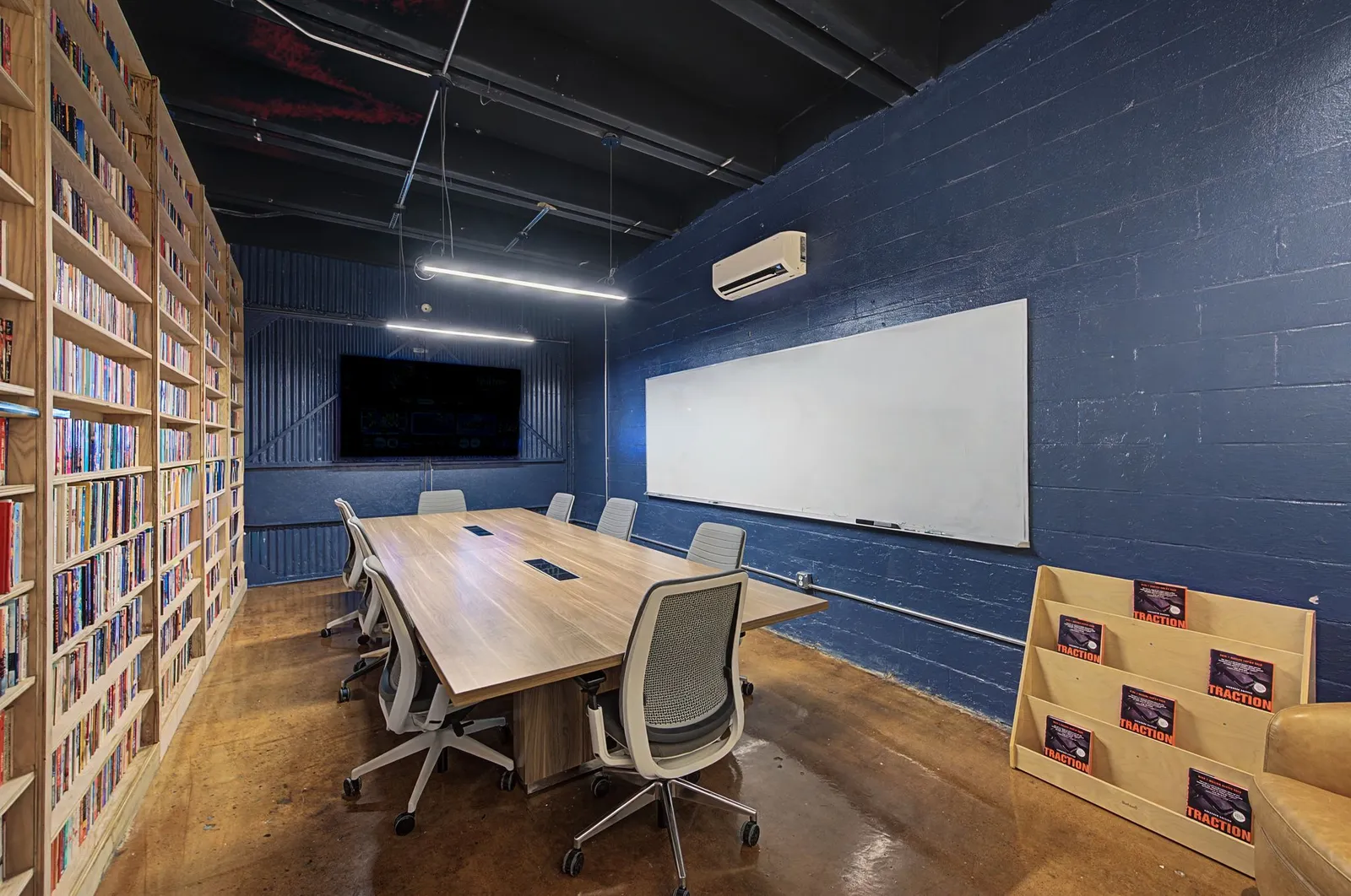 Conference room table with whiteboard and TV for meetings at Music City Work Club in Nashville