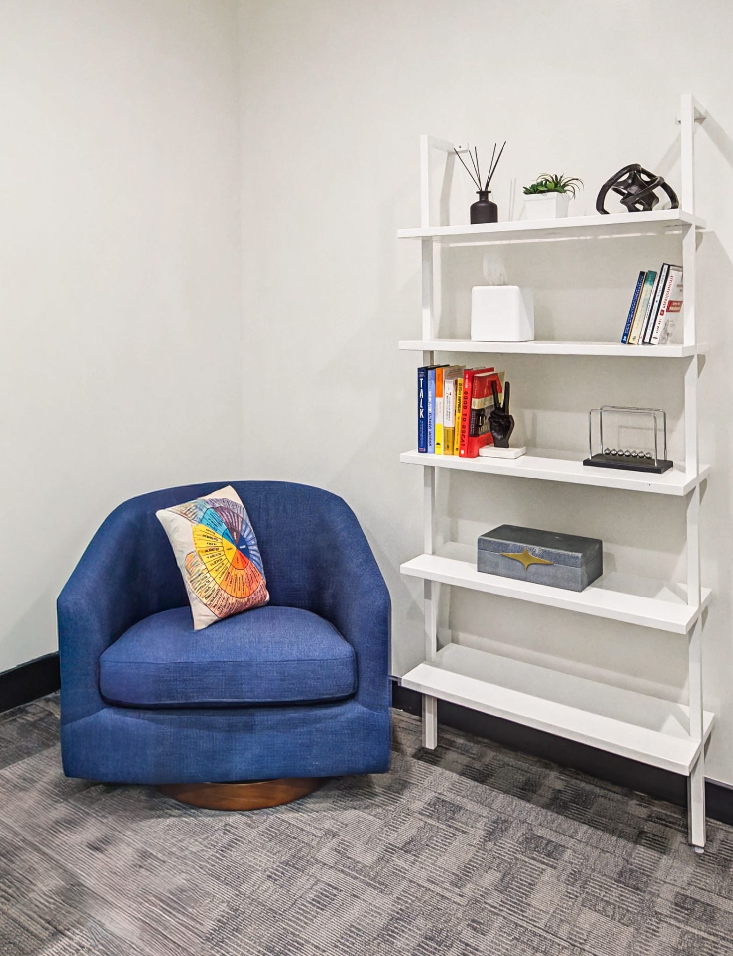 Private office reading nook with blue accent chair