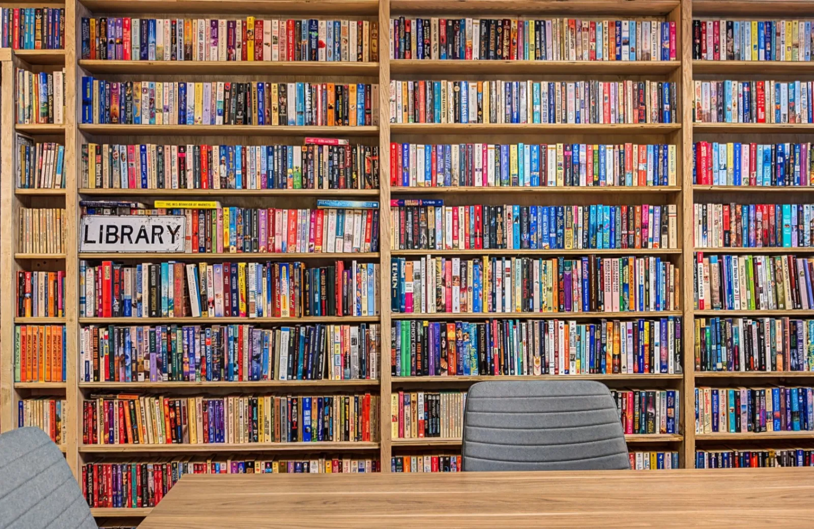 Bookshelf-lined conference room at Music City Work Club for EOS quarterlies and planning sessions